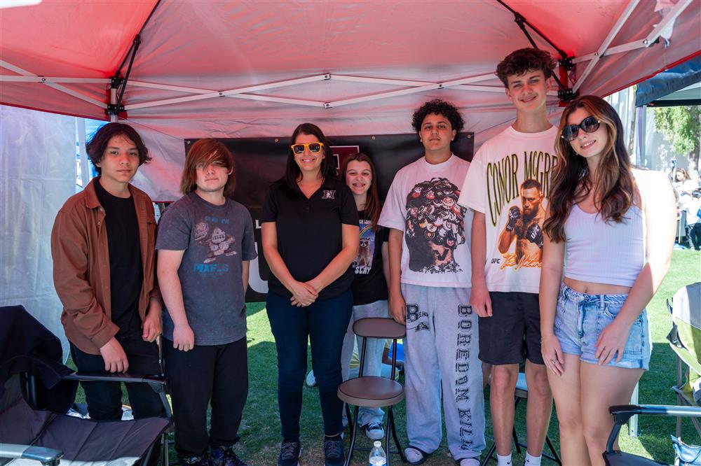 An image of a large group of students by their booth.